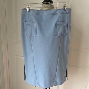 Etcetera sky blue pencil skirt with flare hems at sides and front pockets.